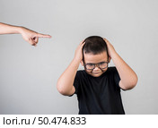 Boy feels sad after the parents scold him. Стоковое фото, агентство Ingram Publishing / Фотобанк Лори