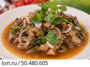 Spicy minced pork in a white plate with Tomatoes, garlic, long beans, sliced ??shallots, chili powder, roasted rice. Стоковое фото, агентство Ingram Publishing / Фотобанк Лори