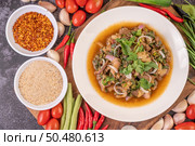 Spicy minced pork in a white plate with Tomatoes, garlic, long beans, sliced ??shallots, chili powder, roasted rice. Стоковое фото, агентство Ingram Publishing / Фотобанк Лори