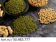  Soybean, peanut, and Mung bean on a black cement floor background. Selective focus. Стоковое фото, агентство Ingram Publishing / Фотобанк Лори