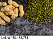 peanut and Mung bean on a black cement floor background. Стоковое фото, агентство Ingram Publishing / Фотобанк Лори