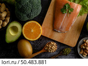 legumes, fruit, and Salmon fish pieces on a wooden chopping board. Стоковое фото, агентство Ingram Publishing / Фотобанк Лори