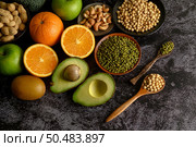 legumes and fruit on a black cement floor background. Стоковое фото, агентство Ingram Publishing / Фотобанк Лори