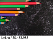 colorful crayon pencils with triangle shape on white background with copy space. Top view. Стоковое фото, агентство Ingram Publishing / Фотобанк Лори
