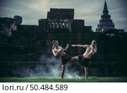 Two boxers fight with the martial arts of Muay Thai. Selective focus. Стоковое фото, агентство Ingram Publishing / Фотобанк Лори