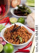 Spicy pork chops in a white dish consisting of lemons, chilies, and side dishes. Selective focus. Стоковое фото, агентство Ingram Publishing / Фотобанк Лори