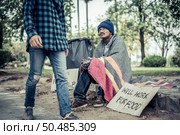 Beggars wrapped in cloth and then put on a hat and sat down beside the street and someone gave money. Стоковое фото, агентство Ingram Publishing / Фотобанк Лори