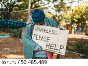 Beggars stand on the street with homeless messages please help. Стоковое фото, агентство Ingram Publishing / Фотобанк Лори