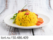 Chicken Biryani in a plate on a white wooden floor. Стоковое фото, агентство Ingram Publishing / Фотобанк Лори