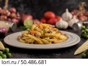 Stir-fried baby corn and carrots with minced pork in a white plate. Selective focus. Стоковое фото, агентство Ingram Publishing / Фотобанк Лори