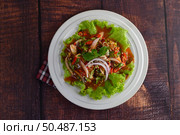 Top view Spicy salad of sardine with tomato sauce mixed with herb and lemon, beautiful decoration by lettuce leaf inviting to hungry in white dish,  copy space. Стоковое фото, агентство Ingram Publishing / Фотобанк Лори