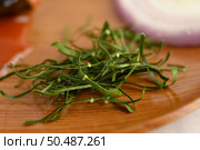 Close up and Selective focus the shredded kaffir lime leaves and blurred herb for cooking ingredient on wooden tray, copy space. Стоковое фото, агентство Ingram Publishing / Фотобанк Лори