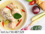 Tom Kha Kai in a bowl with kaffir lime leaves, lemongrass, red onion, galangal and chilli.Selective focus. Стоковое фото, агентство Ingram Publishing / Фотобанк Лори
