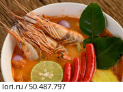 Tom Yum Kung Thai hot spicy soup shrimp with lemon grass,lemon,galangal and chilli on wooden background Thailand Food. Стоковое фото, агентство Ingram Publishing / Фотобанк Лори