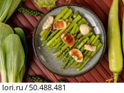 Fried asparagus with oyster sauce in a plate with bell peppers Fresh pepper and tomato. Стоковое фото, агентство Ingram Publishing / Фотобанк Лори