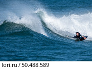 Bodyboarder surfing ocean wave on a sunny winter day. Стоковое фото, агентство Ingram Publishing / Фотобанк Лори