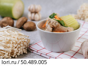 Chicken soup with corn, shiitake mushroom, enoki mushroom, and carrot. Стоковое фото, агентство Ingram Publishing / Фотобанк Лори
