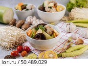 Chicken soup with corn, shiitake mushroom, enoki mushroom, and carrot. Стоковое фото, агентство Ingram Publishing / Фотобанк Лори