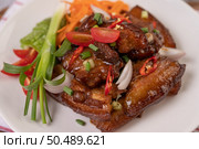 Sweet pork in a white plate with chopped scallions, chili, lime, gourd, tomato and garlic. Стоковое фото, агентство Ingram Publishing / Фотобанк Лори