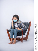 The woman was sick, sat on a chair, and touched her head with her hand. Стоковое фото, агентство Ingram Publishing / Фотобанк Лори