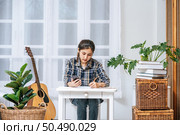 Women sit at the desk and use the phone to coordinate. Стоковое фото, агентство Ingram Publishing / Фотобанк Лори