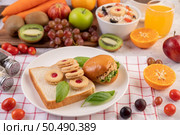 Bread slices, stuffed buns, and burgers on a white plate. Стоковое фото, агентство Ingram Publishing / Фотобанк Лори