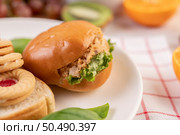Bread slices, stuffed buns, and burgers on a white plate. Стоковое фото, агентство Ingram Publishing / Фотобанк Лори