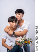 Two men who love each other hug from behind another. Стоковое фото, агентство Ingram Publishing / Фотобанк Лори