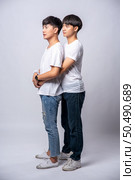 Two men who love each other hug from behind another. Стоковое фото, агентство Ingram Publishing / Фотобанк Лори