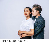 Two female lovers standing and hugging from behind. Стоковое фото, агентство Ingram Publishing / Фотобанк Лори