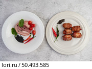 Sausage wrapped pork belly pasted on a plate on a plate and pork belly on a white plate. Стоковое фото, агентство Ingram Publishing / Фотобанк Лори
