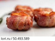 Sausage wrapped pork belly on a white plate. Selective focus. Стоковое фото, агентство Ingram Publishing / Фотобанк Лори