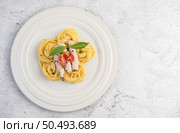 Stir-fried spaghetti and pork, beautifully arranged in a white plate. Стоковое фото, агентство Ingram Publishing / Фотобанк Лори