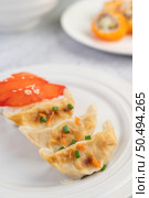 Gyoza beautifully arranged in a white plate. Стоковое фото, агентство Ingram Publishing / Фотобанк Лори