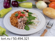 Stir-fried noodles with minced pork, edamame, tomatoes and mushrooms in a white plate. Стоковое фото, агентство Ingram Publishing / Фотобанк Лори