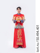Man wear Cheongsam suit and black shoe give gold to his relative for lucky in chinese new year. Стоковое фото, агентство Ingram Publishing / Фотобанк Лори
