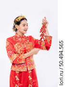 woman wear Cheongsam suit smile to get Firecrackers from boss in chinese new year. Стоковое фото, агентство Ingram Publishing / Фотобанк Лори