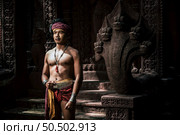Portrait Handsome shirtless man in turban on head and beautiful silver ornament, The actor in Perform on legend love popular story, Thai Isan folktale called "Phadaeng and Nang-ai" in acient site. Стоковое фото, агентство Ingram Publishing / Фотобанк Лори