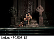 Young Actor and Actress wearing beautiful ancient costumes, in ancient monuments, dramatic style. Perform on legend love popular story, Thai Isan folktale called "Phadaeng and Nang-ai" in acient site. Стоковое фото, агентство Ingram Publishing / Фотобанк Лори