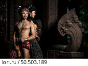Young Actor and Actress wearing beautiful ancient costumes, in ancient monuments, dramatic style. Perform on legend love popular story, Thai Isan folktale called "Phadaeng and Nang-ai" in acient site. Стоковое фото, агентство Ingram Publishing / Фотобанк Лори