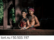 Young Actor and Actress wearing beautiful ancient costumes, in ancient monuments, dramatic style. Perform on legend love popular story, Thai Isan folktale called "Phadaeng and Nang-ai" in acient site. Стоковое фото, агентство Ingram Publishing / Фотобанк Лори