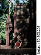 Young female Actress wearing beautiful ancient costumes, in ancient monuments, dramatic style. Perform on legend love popular story, Thai Isan folktale called "Phadaeng and Nang-ai" in acient site. Стоковое фото, агентство Ingram Publishing / Фотобанк Лори