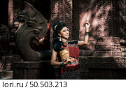 Young female Actress wearing beautiful ancient costumes, in ancient monuments, dramatic style. Perform on legend love popular story, Thai Isan folktale called "Phadaeng and Nang-ai" in acient site. Стоковое фото, агентство Ingram Publishing / Фотобанк Лори