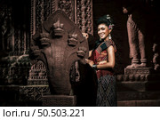 Young female Actress wearing beautiful ancient costumes, in ancient monuments, dramatic style. Perform on legend love popular story, Thai Isan folktale called "Phadaeng and Nang-ai" in acient site. Стоковое фото, агентство Ingram Publishing / Фотобанк Лори