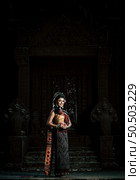Young female Actress wearing beautiful ancient costumes, in ancient monuments, dramatic style. Perform on legend love popular story, Thai Isan folktale called "Phadaeng and Nang-ai" in acient site. Стоковое фото, агентство Ingram Publishing / Фотобанк Лори