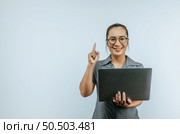 Portrait of Successful Aisan businesswoman glasses holding laptop and getting idea on isolated background. Success and SME business concept. Стоковое фото, агентство Ingram Publishing / Фотобанк Лори