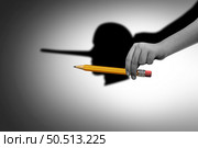 Concept Of Cheating and creative fraud as a cheater or con-artist hilding a pencil as a liar who cheats and scams as a corruption symbol for dishonesty with 3D illustration elements. Стоковое фото, агентство Ingram Publishing / Фотобанк Лори