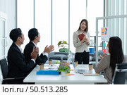 Young asian woman freshmen in the new generation of entrepreneurs team. Successfully presented the project to the satisfaction of the management. Стоковое фото, агентство Ingram Publishing / Фотобанк Лори