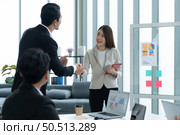 Young asian woman freshmen in the new generation of entrepreneurs team. Successfully presented the project to the satisfaction of the management. Стоковое фото, агентство Ingram Publishing / Фотобанк Лори