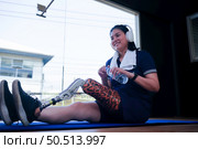 Young female with one prosthetic leg with the practice of using prosthetic legs to walk, exercise and and daily activities. Стоковое фото, агентство Ingram Publishing / Фотобанк Лори